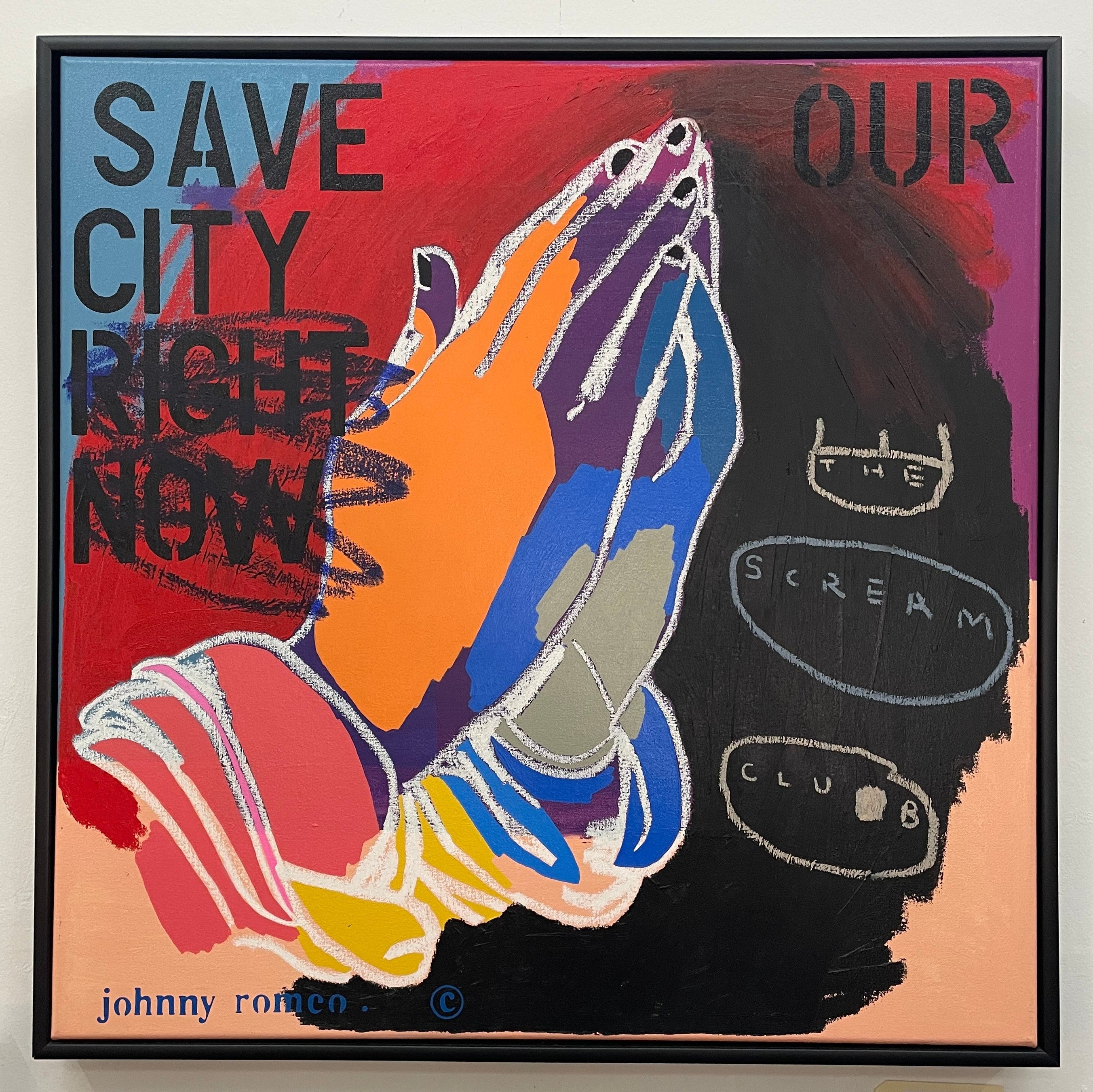 Colorful painting with praying hands and text on a white wall